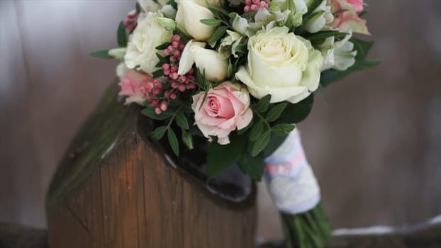 Wedding bouquet of roses. Bride's bouquet on wedding day. Bouquet of different flowers. Bouquet of beautiful pink and white or red roses on the dressing stool. Roses HD