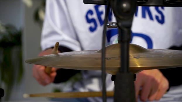 The drummer in action. Cose up process play on a musical instrument. Clip. A plate of the drum set. Close-up. Hand of drummer with sticks and drums, close-up.