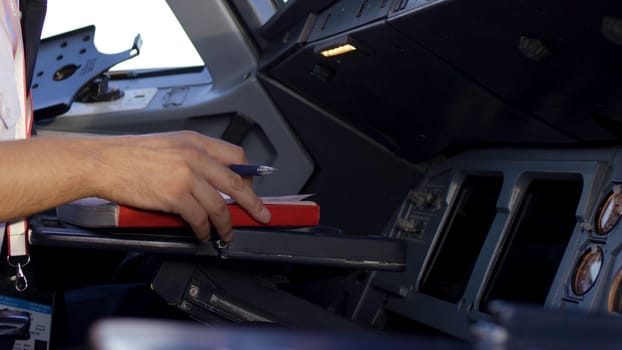 Rear view of pilot operating controls of corporate jet. the pilot checks all the systems. Rear view of pilot and copilot operating controls of corporate jet. Pilot and copilot in commercial plane