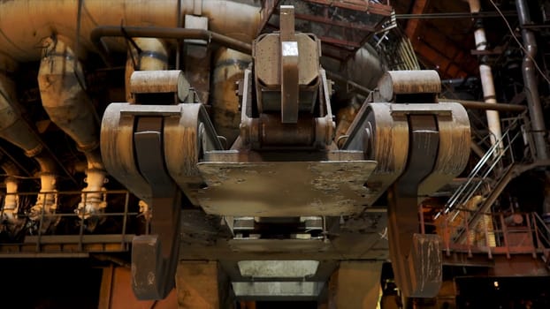 Close up for big hooks of the metallurgical chute at the factory, heavy industry concept. Mechanisms of metallurgical plant