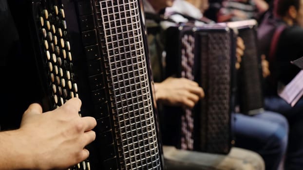 The musician playing the accordion. Close-up, musicians playing the accordion. Group of musicians playing the accordion.