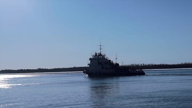 Huge floating vessels in inclement weather. Clip. The navy sails in the winter against the background of the blue sky. High quality FullHD footage