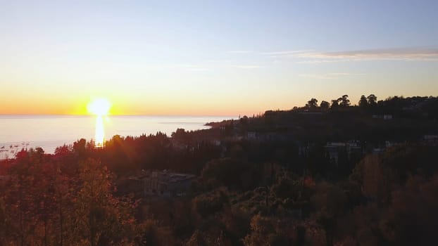 Aerial view - landscape of tree, mountain from the top of mountain in sunset time. Clip. Top view of the mountain city at sunset.