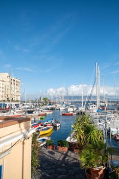 Napoli, Italy: 2023 November 13: Porticciolo Santa Lucia di Napoli on a sunny day with Vesuvius in the background in the year 2023.