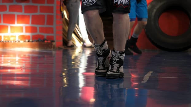 Man jumping rope at the gym. Male boxer legs jumps rope.