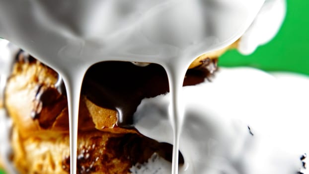 Buns and dough products, sweet baked appetizing and delicious dessert on a green background. Stock clip. Close up of pouring white chocolate on buns