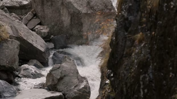 Slow-motion shooting of waterfall in rocks. Creative. Beautiful currents and cascades of waterfall among rocks. Cascading waterfall flow in rocks.