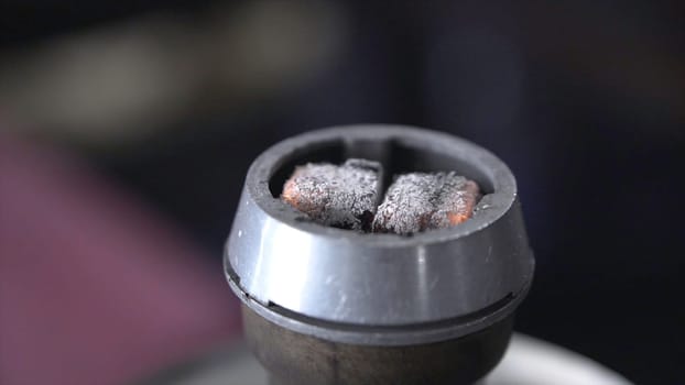 Shisha hookah with red hot coals.Clip. Modern hookah with coconut charcoal for relax and shisha smoke.