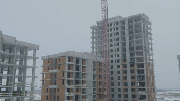 Apartments construction site with crane. Crane and building construction.