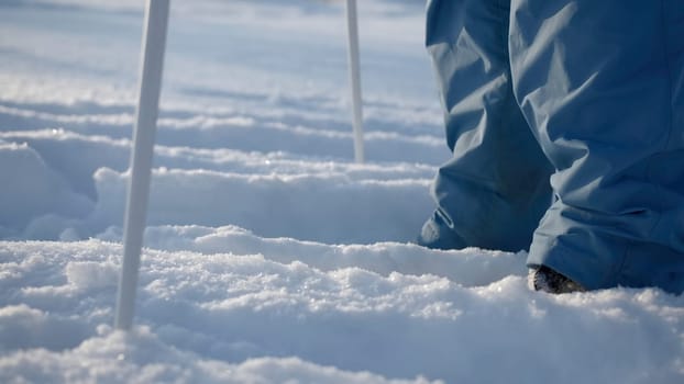 A boy skiing. Creative. A child who stands in the white snow and holds big sticks. High quality 4k footage