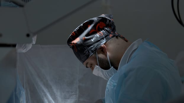 Portrait of a surgeon preparing for the procedure at work in a hospital. Action. Sterile operating theatre