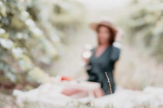 Picnic and wine tasting at sunset in the hills of Italy, Tuscany. Vineyards and open nature in the summer. Romantic dinner, fruit and wine.