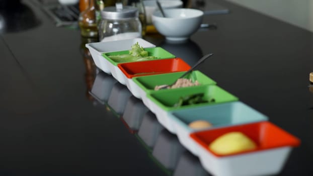 Close-up of ingredients in plates before cooking. Art. Small plates with cooking ingredients. Ingredients for cooking in professional kitchen.