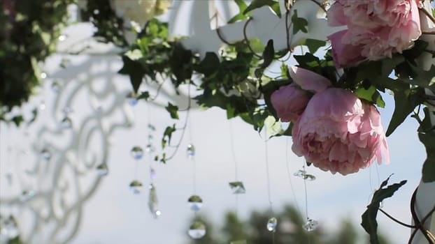 Part of the festive decor, floral arrangement. Detail of a wedding arch. Wedding decoration ceremony (Chandelier in the arch of flowers). Wedding decoration. Arch. Cage. Wedding setup on the beach. wedding arch decorated with flowers. Diamonds HD