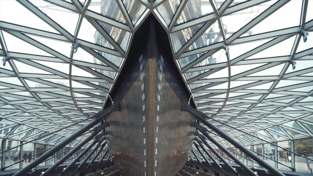Close-up of the people walking inside of the Cutty Sark ship museum. Built on the Clyde in 1869, it was one of the world's fastest tea clippers.