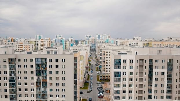 Summer landscape of a new city district on a summer sunny day. Video. Aerial view of newly built high rise residential houses of white and other bright colors, concept of urbanization