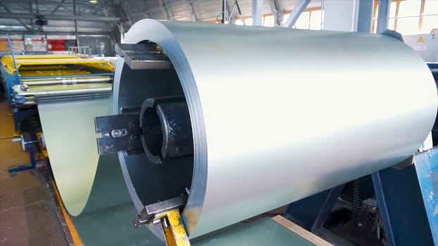 Rolled steel. Stack of rolls, Cold rolled steel coils in action. Galvanized Steel Sheet and rusty rim. Cold rolled steel coils. he drum turns the metal sheets in the production. Industrial and manufactore of steel