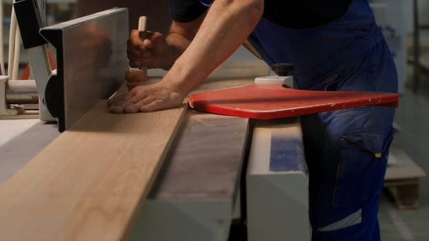 Industrial background with details of the workshop of the woodworking factory. Creative. Carpentry worker with a wooden board