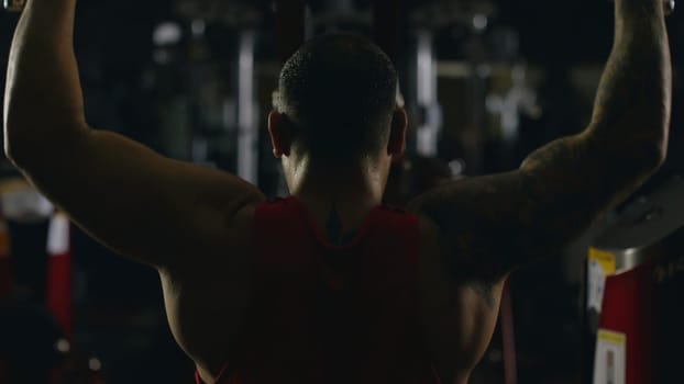 Sportsman athlete bodybuilder trains in the gym. Handsome muscular sports man in fitness club, top view. Fighter 4K
