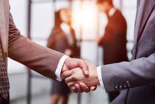 Nice to meet you. Close-up of two young businessmen shaking hands