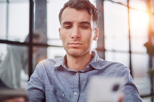 man selects a credit card from several and enters it number into a smartphone to pay online. Online shopping, lifestyle technology.