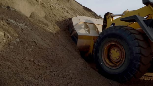 View from the bottom .Scene.Large tractors on an empty mountain , the construction process. High quality FullHD footage