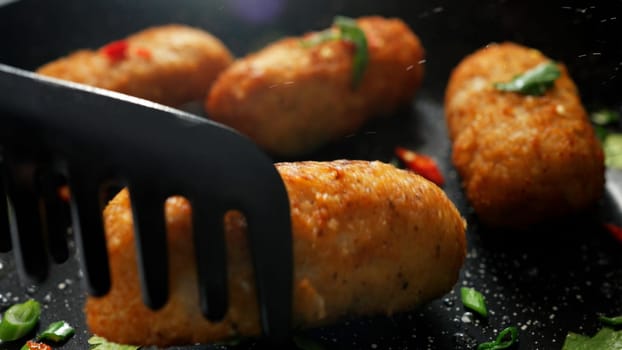 The cooking process. Stock footage. Frying meat cutlets with vegetables in hot pans. High quality 4k footage