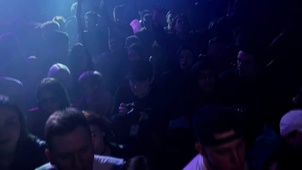 Poland - Warsaw, May 28, 2023: night club party with flashing lights and paying DJ. Clip. Concept of having fun and youth