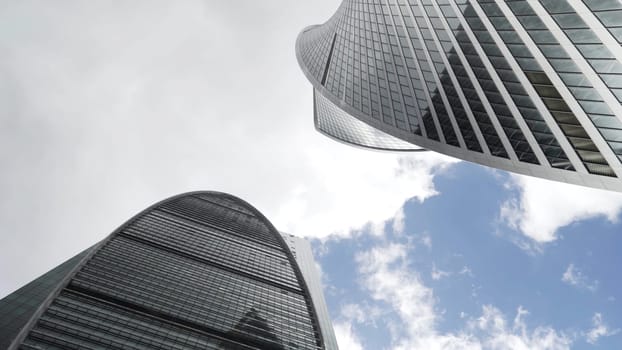 Concept of modern architecture. Bottom view of stunning Moscow International Business Center on blue cloudy sky background, Russia.