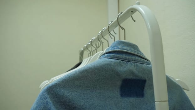 Clothes hang on a shelf in a designer clothes store. Clothes hanger.