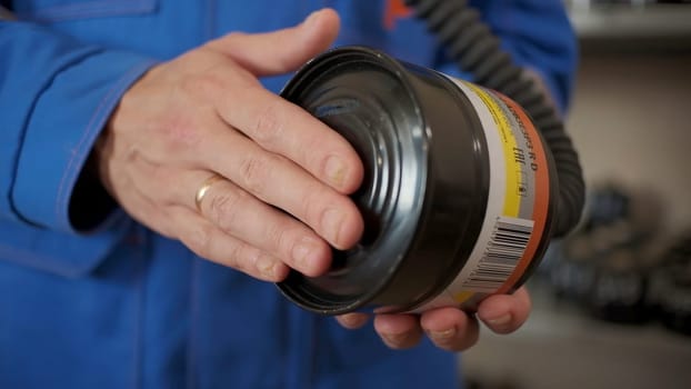 Close up of fireman holding professional filter of labor protection. Clip. Detail of emergency workers routine