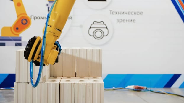 Robotic arm on industrial unloading. Media. Modern robotic technology in industry. Mechanical hands help in unloading heavy products in warehouses.