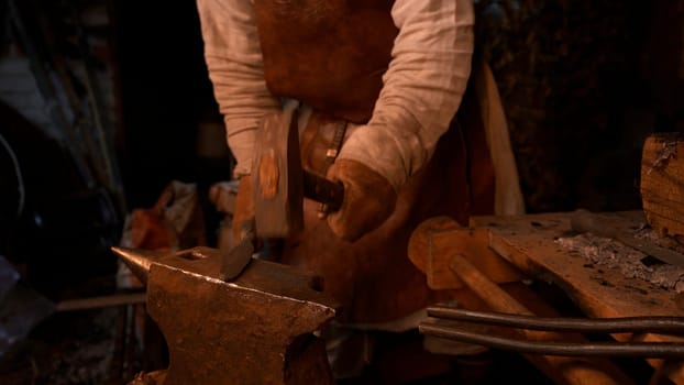 Work in a factory. Media. A specially trained man in ancient Russian clothes works with iron and high temperature. High quality 4k footage