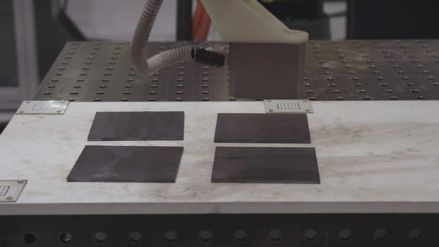 Robotic hand machine tool at industrial manufacture factory. Robotic arm uses magnet to transport metal sheets. Industry, Robot concept .The robot arm is working smartly in the production department, the future factory