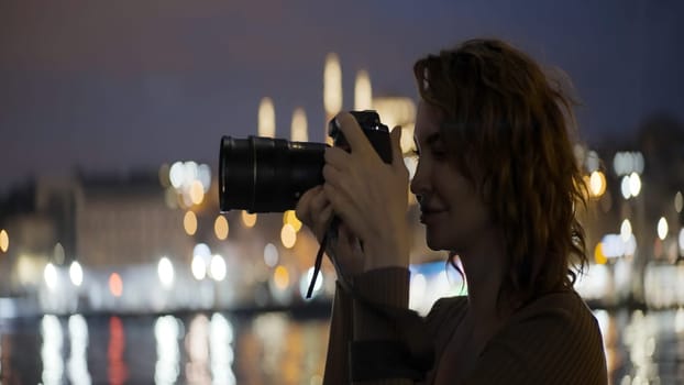 Young pretty woman photographer. Action.A professional camera in the hands of a master photographer who shoots in different places of the city in the evening and in the afternoon. High quality 4k footage
