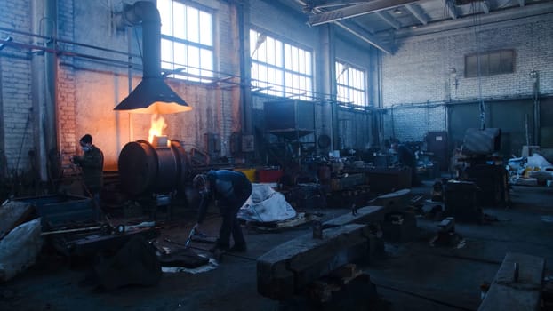 Iron and steel factory workers. Stock footage. Inside the factory of metal forms.