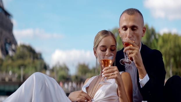 Flirting people on a date. Action. A happy young couple in beautiful clothes drinking champagne on the street. High quality 4k footage