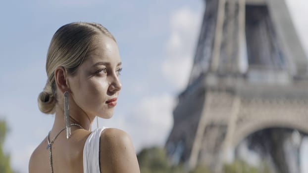 Gorgeous blonde bride on the background of the Effel tower in Paris, France. Action. Wedding day and an elegant woman