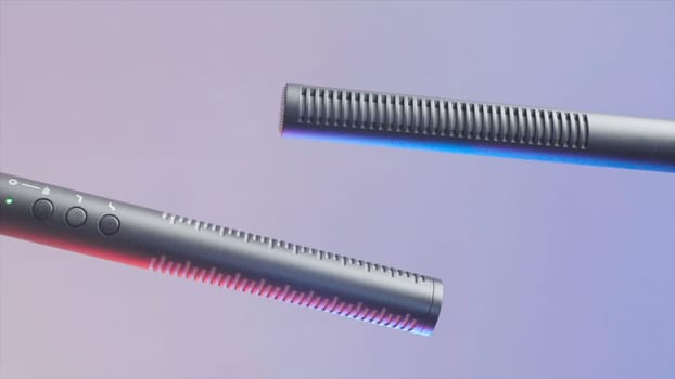 Two microphone on isolated background. Action. Modern professional microphones for high-quality sound recording. Microphone cannon on purple background. Long microphone for singing.