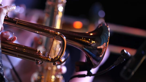 Pipes in the hands of musicians. Musicians playing wind instruments.