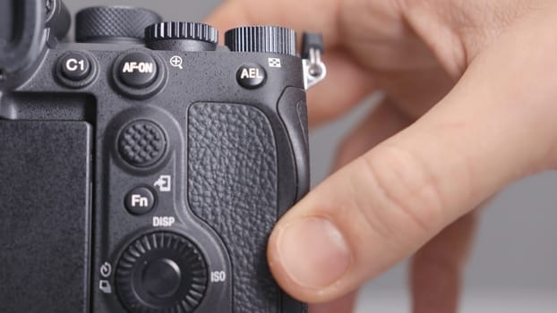 RUSSIA, MOSCOW-DECEMBER, 2020: Memory card in camera. Action. Close-up photographer inserts new memory card into camera. Replacing memory card in camera.