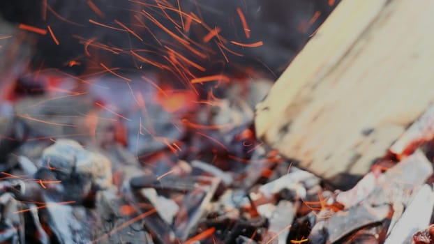 Close-up of burning coals for grill. Concept. Burning black coals for cooking on grill. Coals are burning and smoldering. Barbecue and grill season.