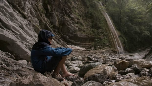 Beach with tourists. Creative. Running children in good weather near the sea and river and mountains overgrown with thickets. High quality 4k footage