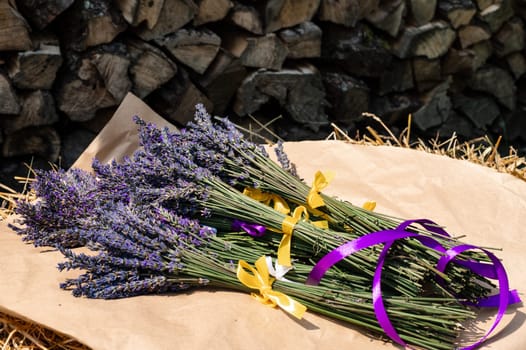 Lavender bouquets with purple and yellow ribbons lie on kraft paper