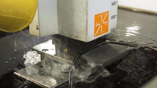 The abrasive water jet machine cutting the aluminium plate. The modern technology of sheet metal working process by high pressure water jet machine.