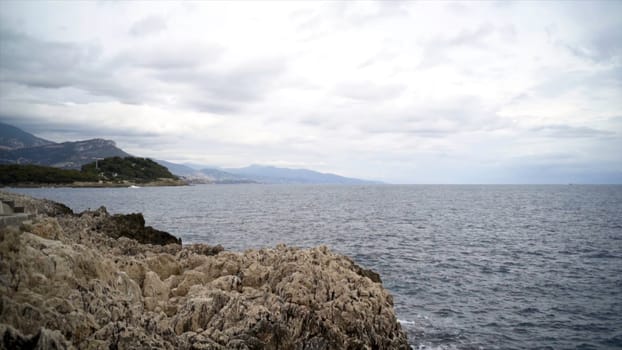 Panoramic view of nice colorful huge cliff and sea. Action. View of the rocks and waves of the sea.
