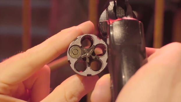 Drum of a revolver close-up. Drum of a revolver with one cartridge closeup.