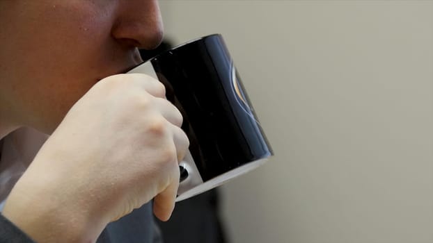 Businessman having a coffee break. close up business man with coffee cup. Close up male arm holding plastic money. He drinking cup of coffee. Break concept.