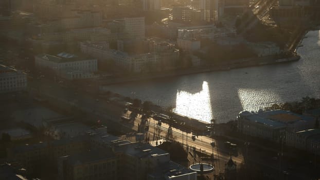 Aerial view of large russian city, buildings, trees near the river in summer morning against blue cloudy sky. Beautiful urban landscape