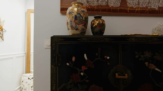 Interior with antique vases and furniture. Creative. Stylish furniture and vases with expensive antique pattern. Expensive antique furniture in interior of modern apartment.